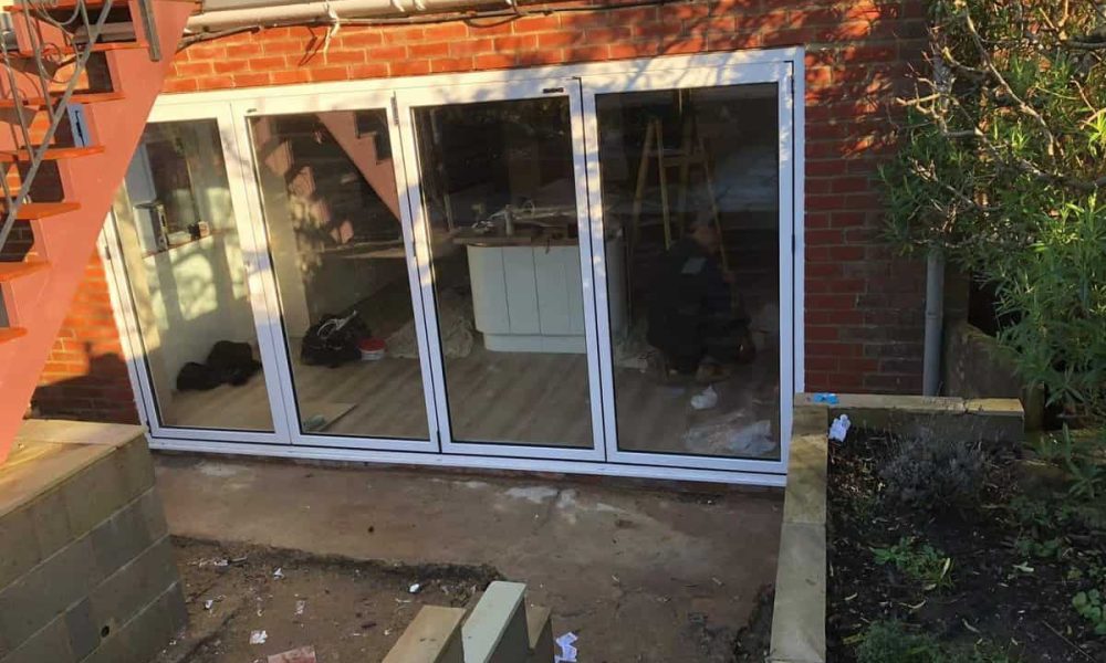 A sliding patio door is being installed in a house.