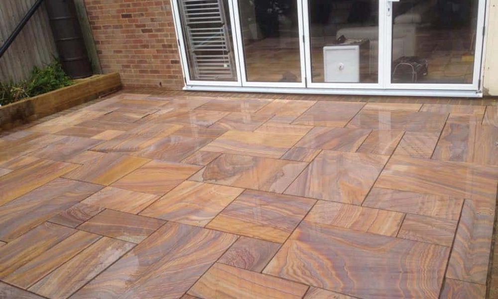 A patio with a brown tiled floor.