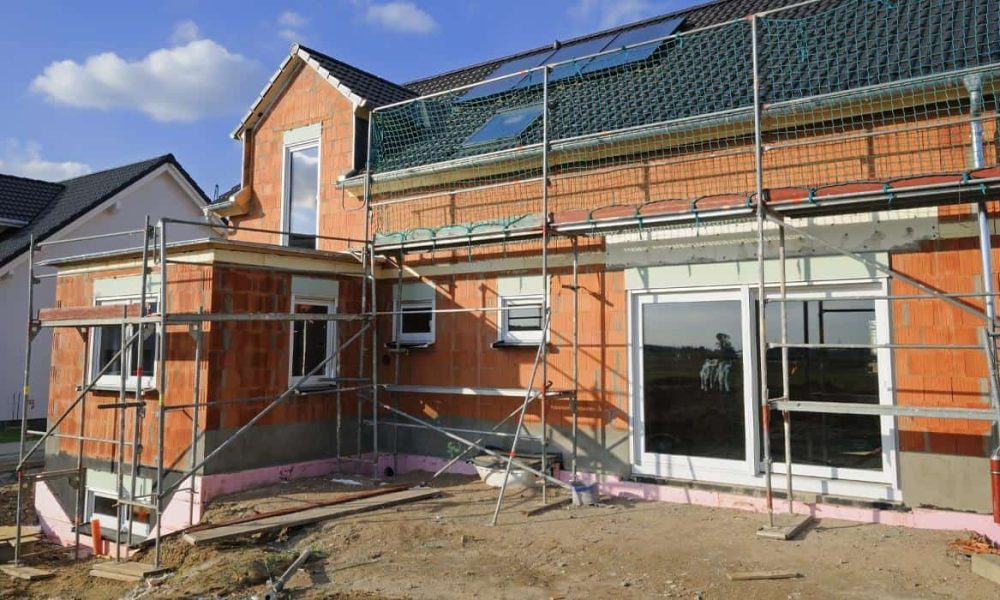 A house under construction with scaffolding.